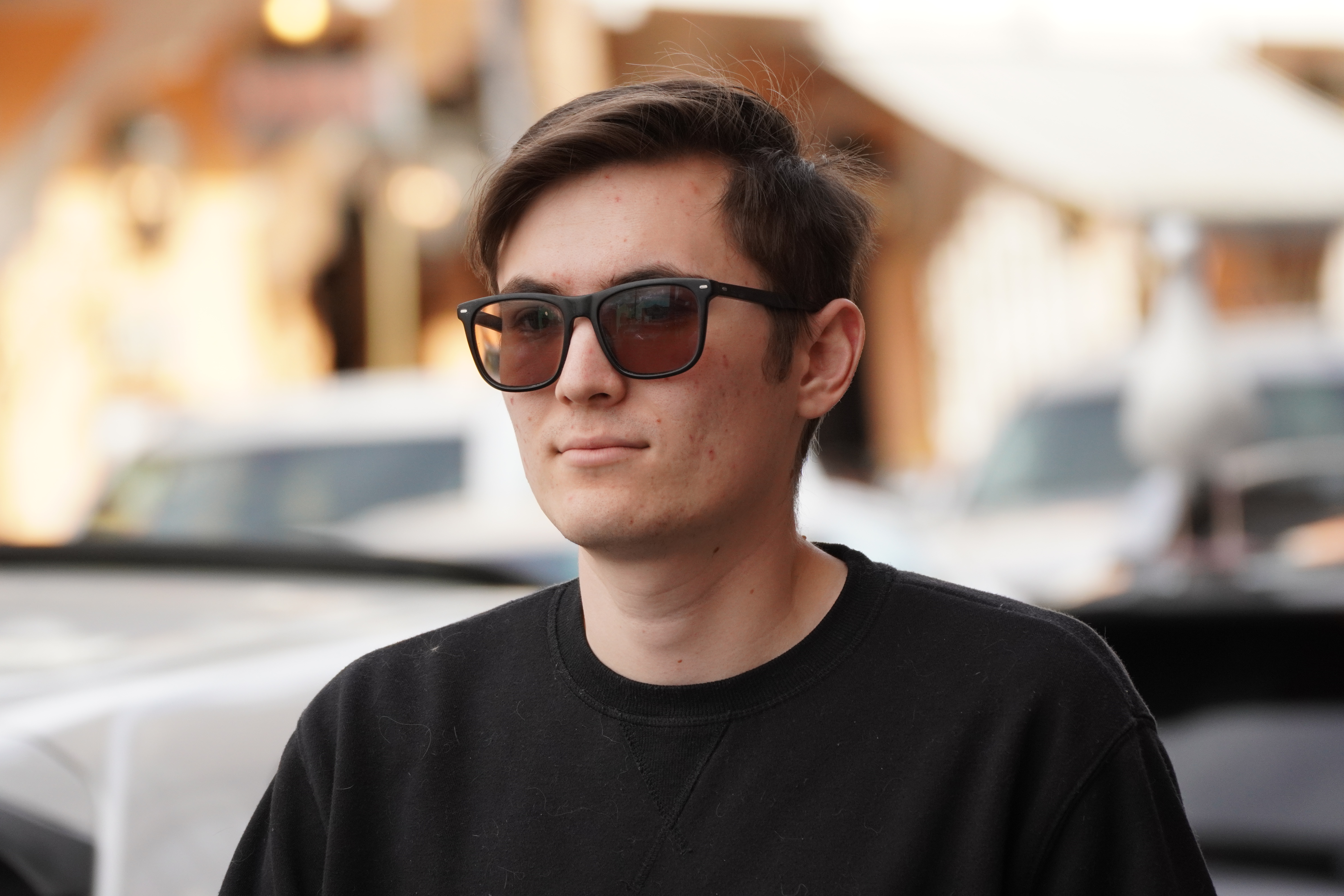 Portrait of a young man wearing glasses outdoors